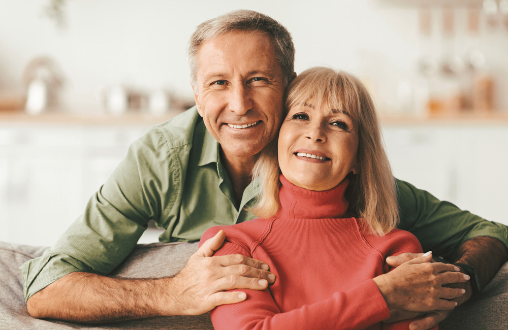 Smiling couple sitting together at home