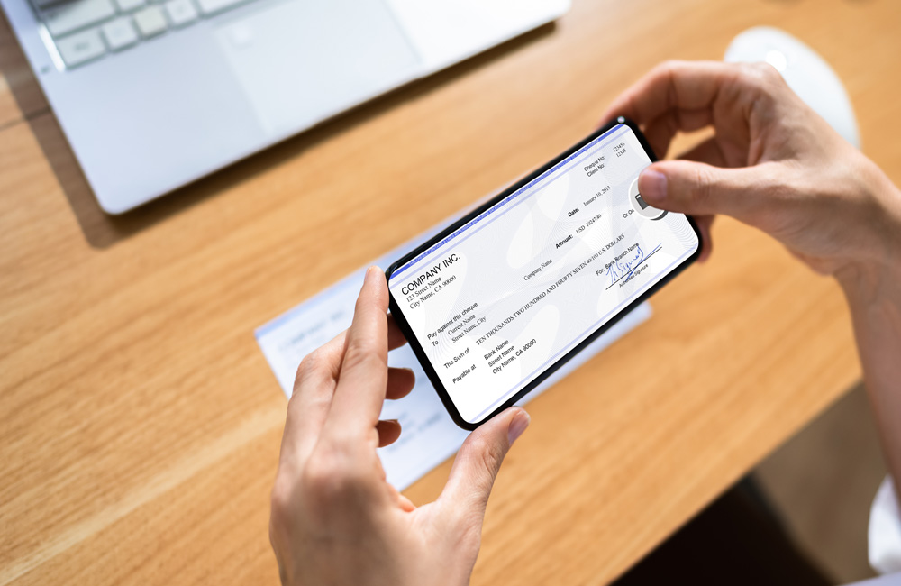 Person using a smartphone to deposit a check remotely