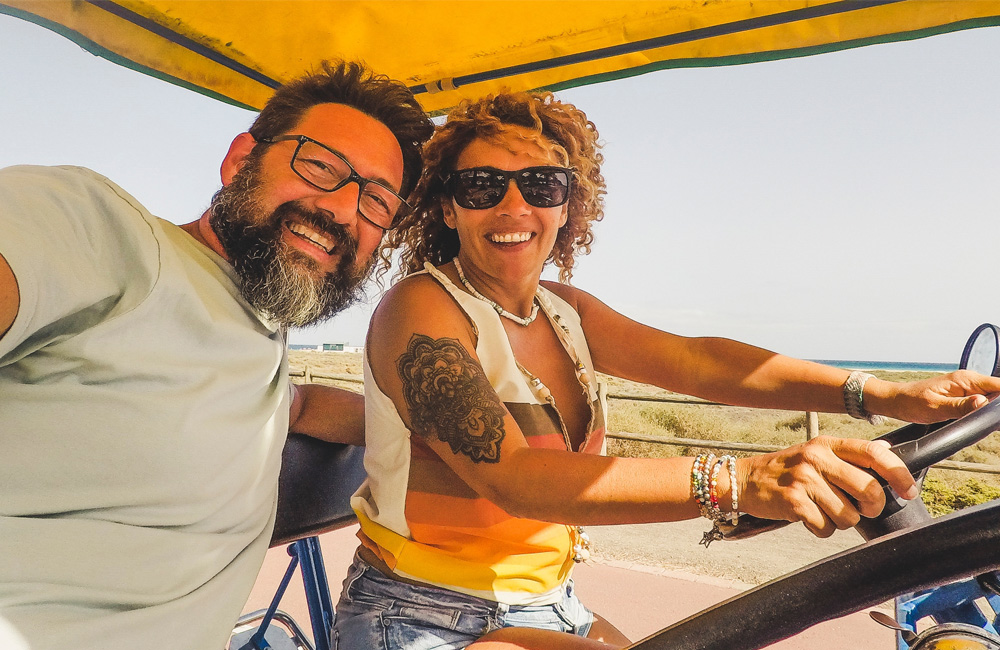 Happy couple smiling on their golf cart ride