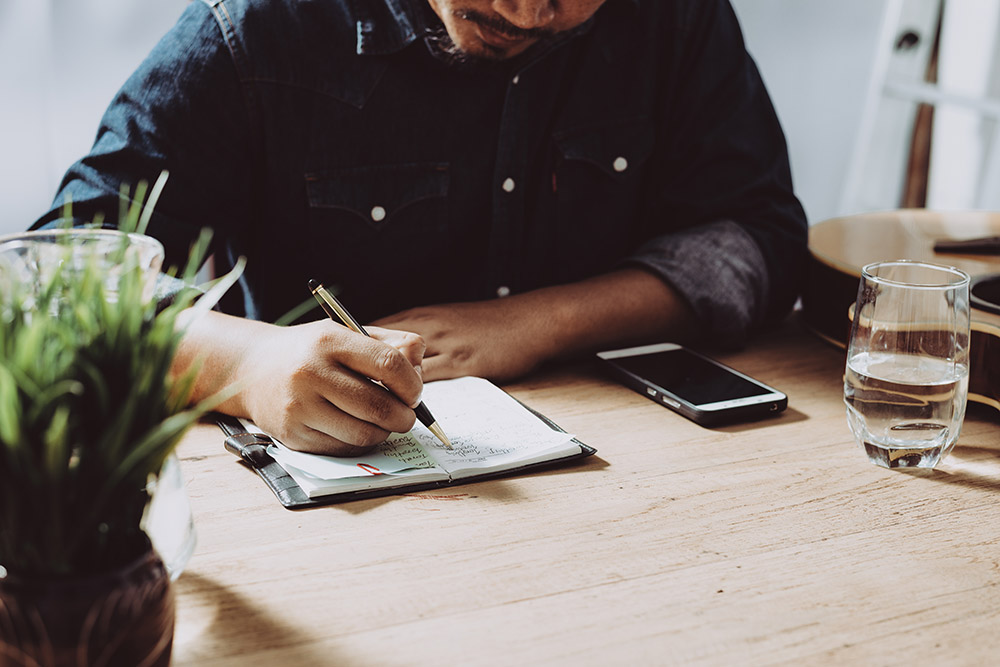 Person reviewing and signing financial documents