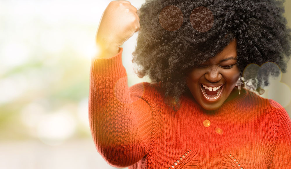 Person celebrating with a raised fist and smiling