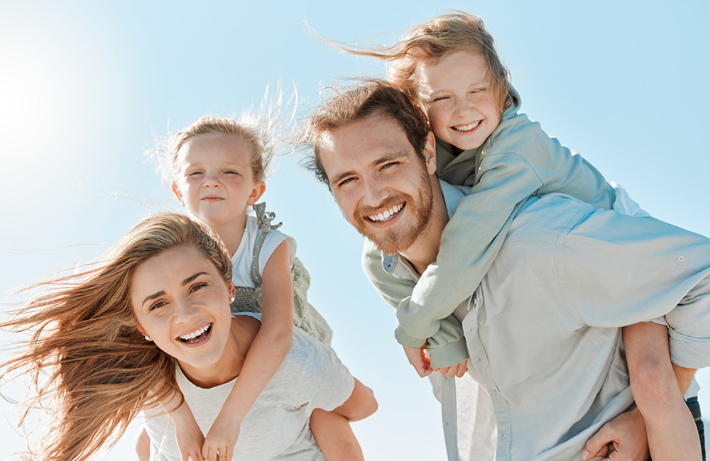 Family smiling with their children