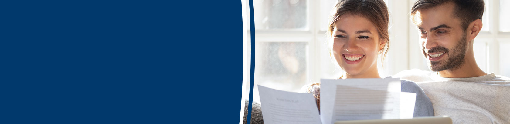 Couple reviewing financial documents together at home