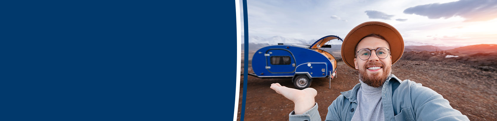 Person taking a selfie in front of a travel trailer