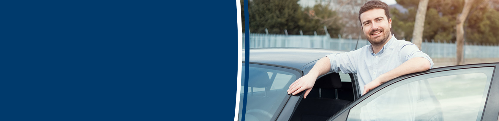 Person standing beside their vehicle with the driver's door open