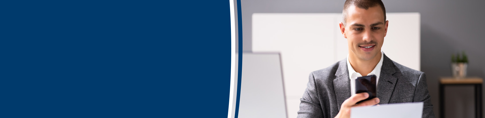 Person using a smartphone while reviewing a document