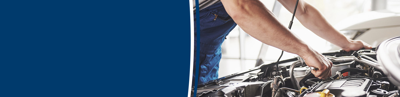 Mechanic inspecting a vehicle engine