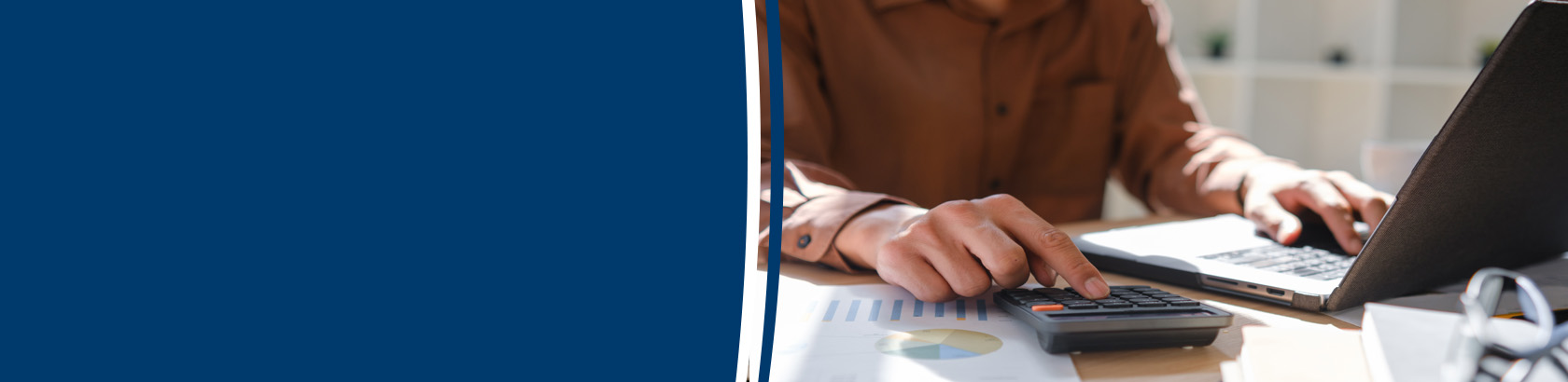 Business owner processing employee payroll at a desk