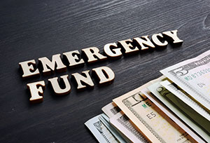 Dollar bills and a text Emergency Fund.