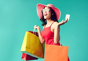 Woman holding shopping bags and a debit card
