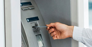 A man using an ATM with a Debit Card