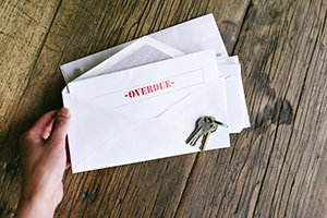 Envelopes with a letter stating overdue.