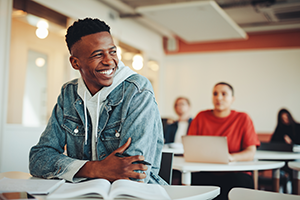 Young student sitting at a desk in a classroom