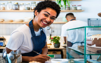 Young woman working at a caffe shop